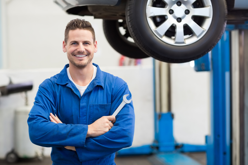 Mechanic performing transmission inspection