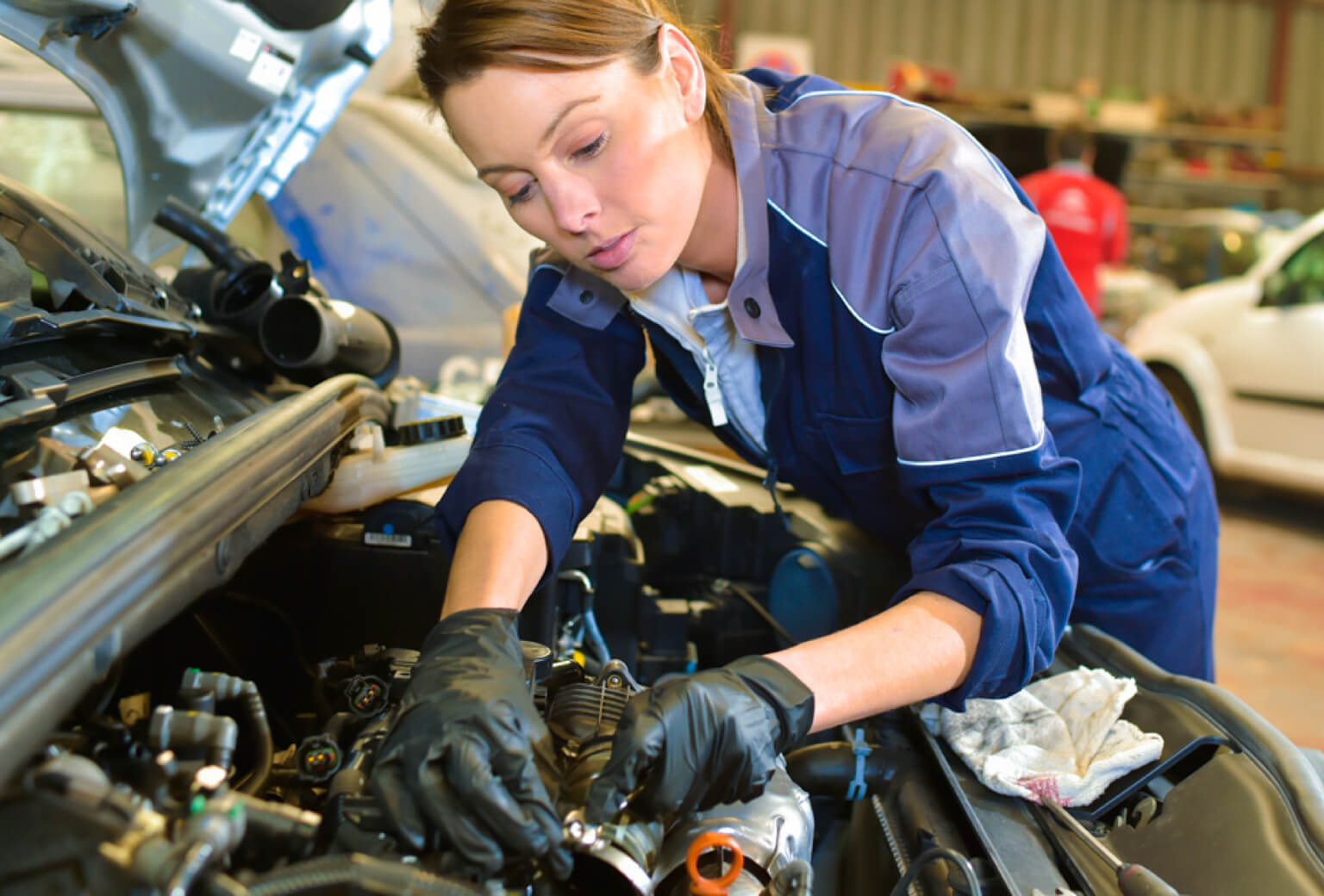 Professional mechanic working on car